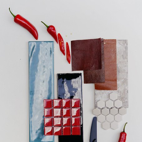 A selection of tiles in different shapes and colours including blues, whites and reds.