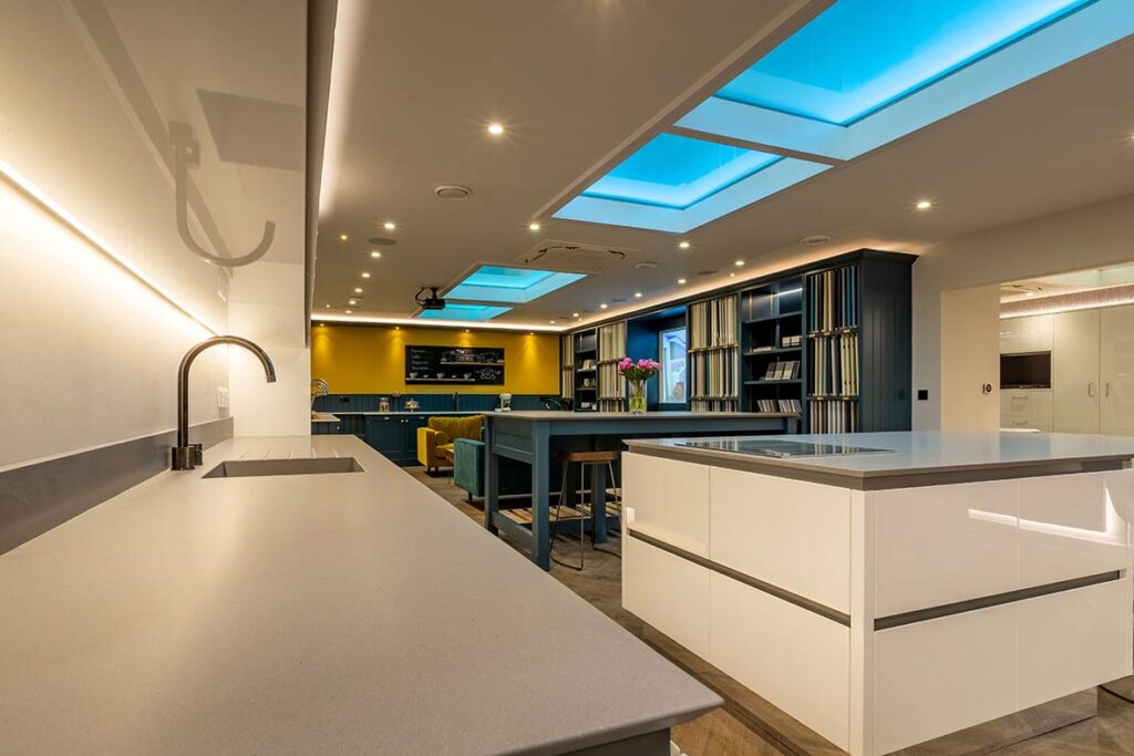 handleless gloss white breakfast bar in kitchen showroom