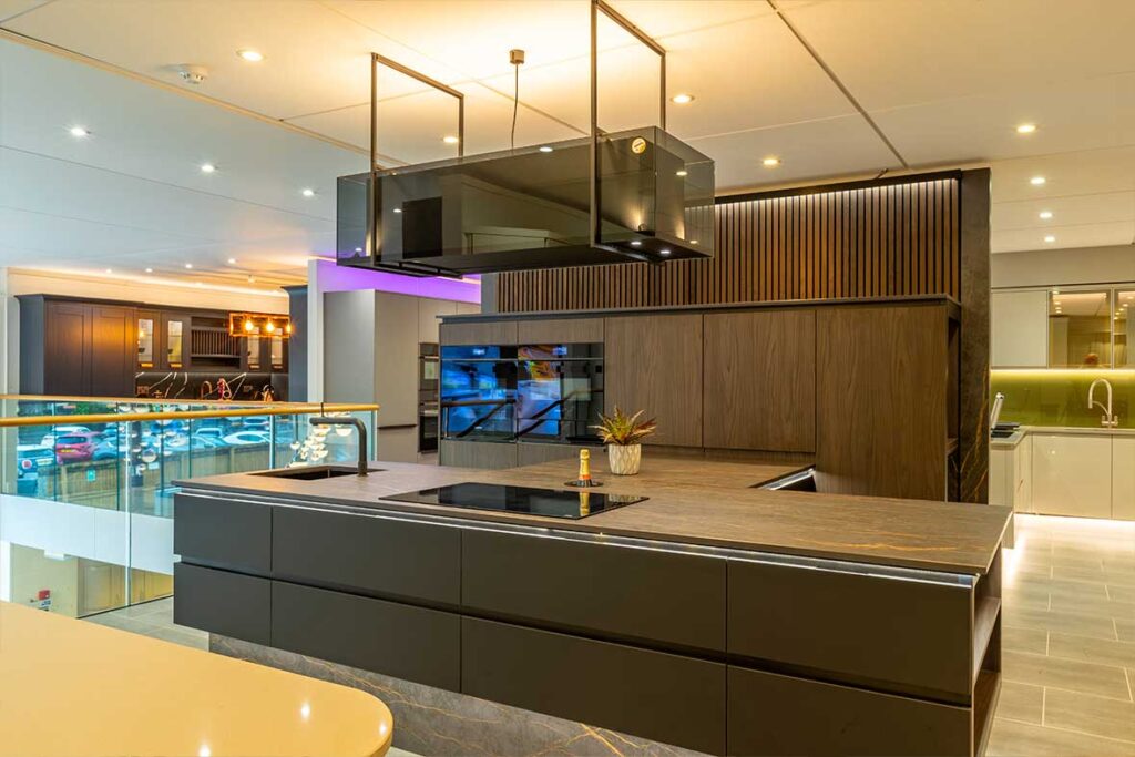 dark wood kitchen display with black glass extractor fan